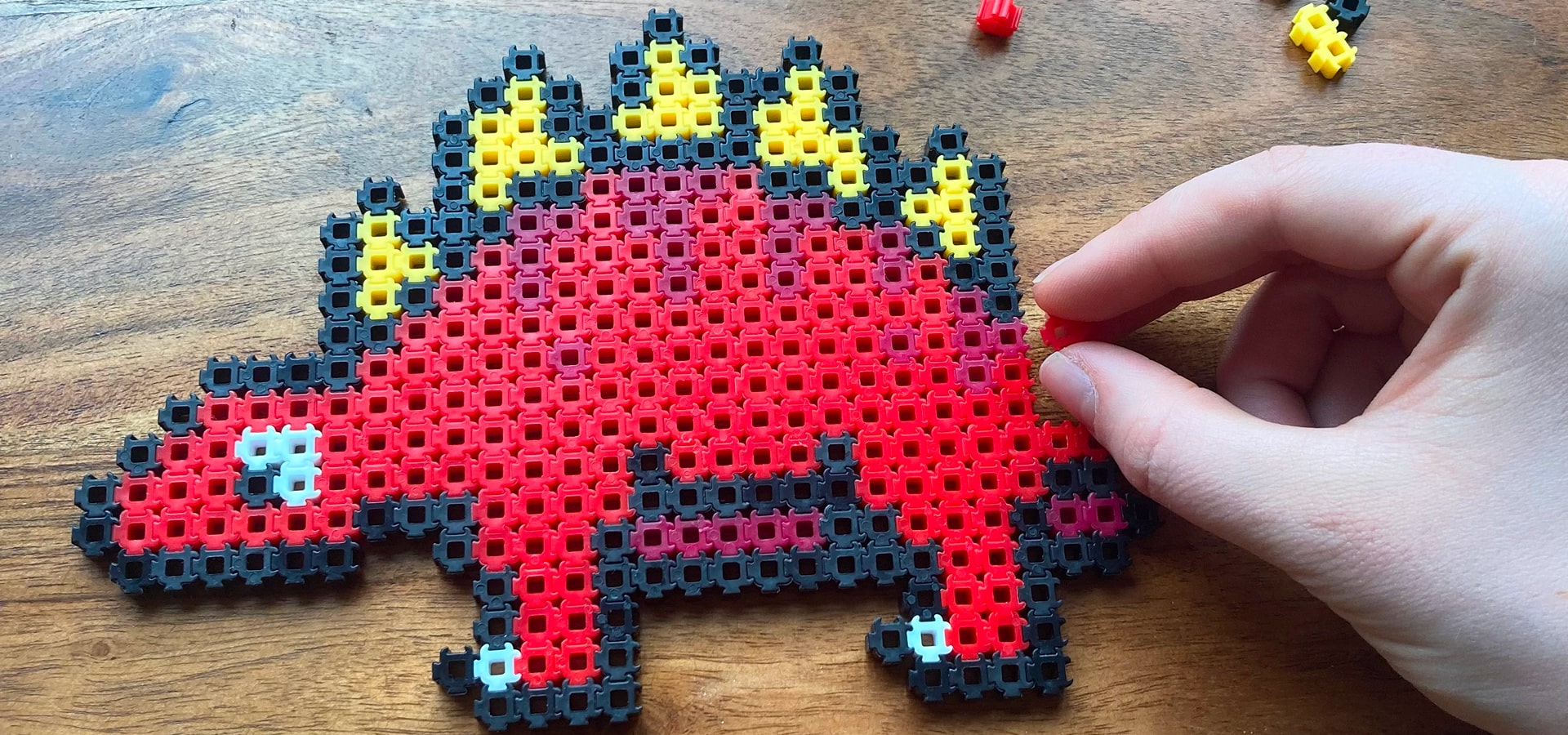 Large pixel dinosaur made from Simbrix colour bricks